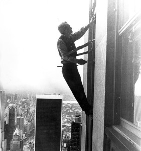 man cleaning outside window