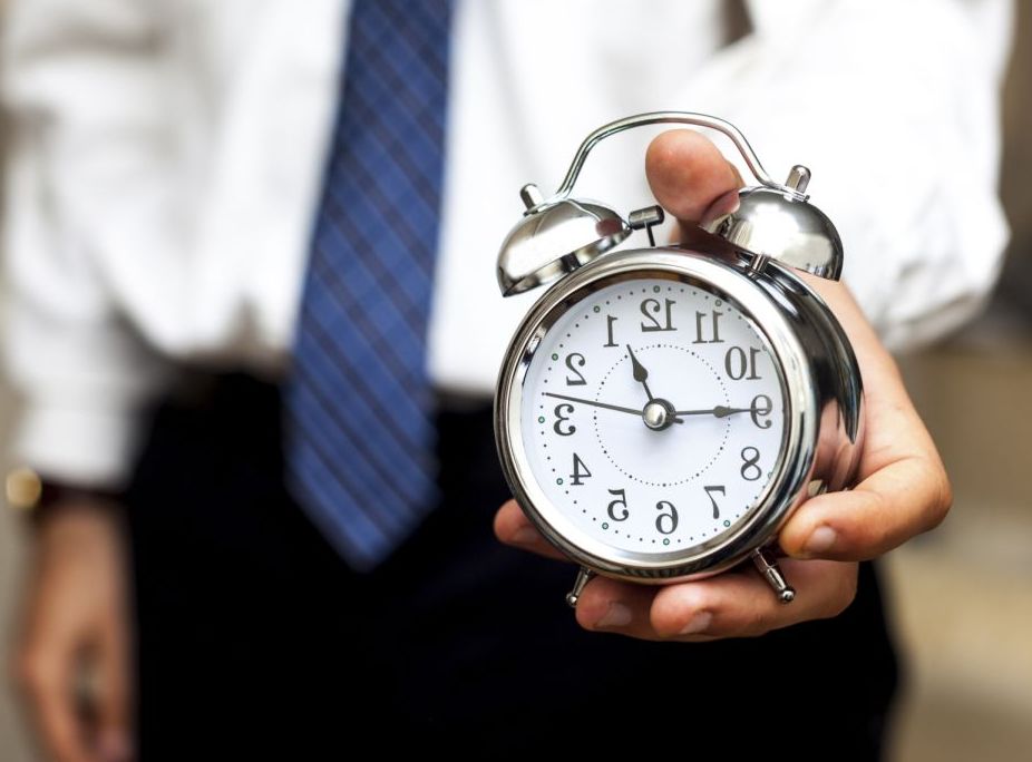 man holding alarm clock
