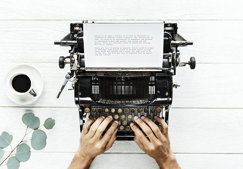 man's hand typing documents