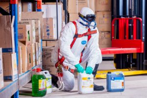 a man in biohazard mask taking care of chemicals